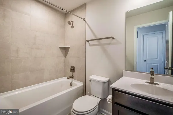 a bathroom with a sink a toilet and a bathtub