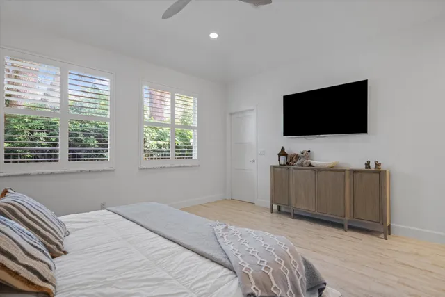 a bedroom with a bed and a flat screen tv