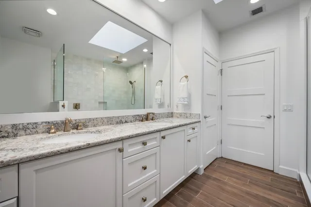 a bathroom with a granite countertop sink mirror and double