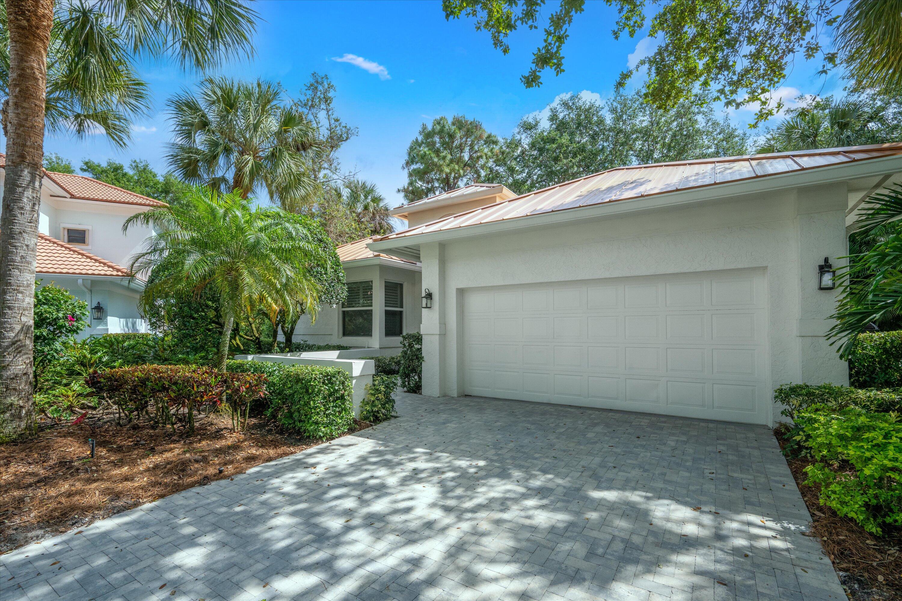 106 Toteka Circle Jupiter, FL 33458 - Photo 2 of 27 a view of a house with a yard