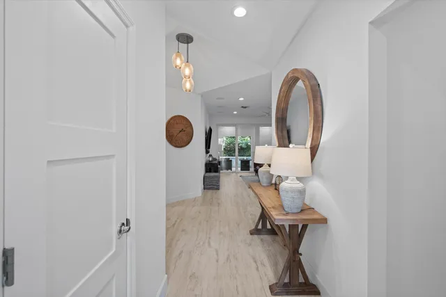 a view of a room with wooden floor and furniture