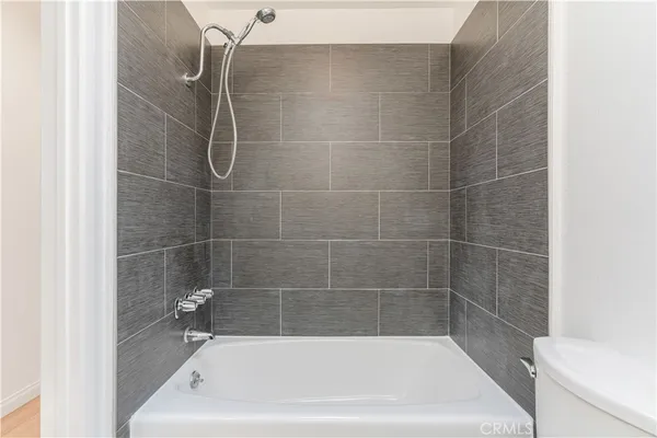 a bath tub sitting next to a white toilet