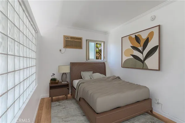 a bedroom with a bed and a painting on the wall