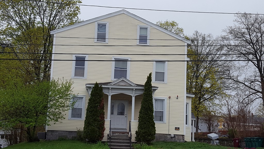 124 Stevens Street, Unit 3 Lowell, MA 01851 - Photo 1 of 18 a front view of a house with a garden