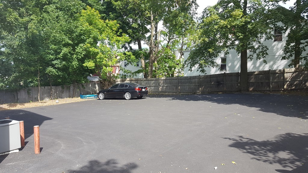 124 Stevens Street, Unit 3 Lowell, MA 01851 - Photo 4 of 18 a car parked on the side of a road