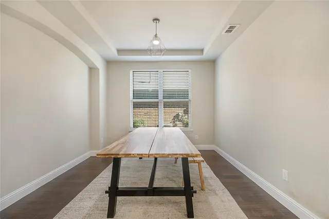 a view of a livingroom with furniture a ceiling fan and wooden floor