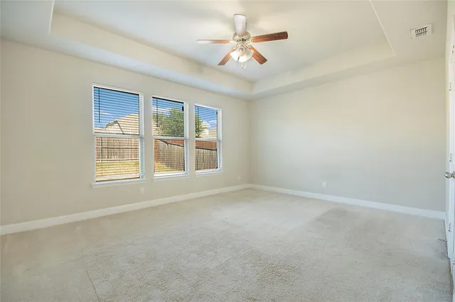 a living room with furniture a fireplace and a large window