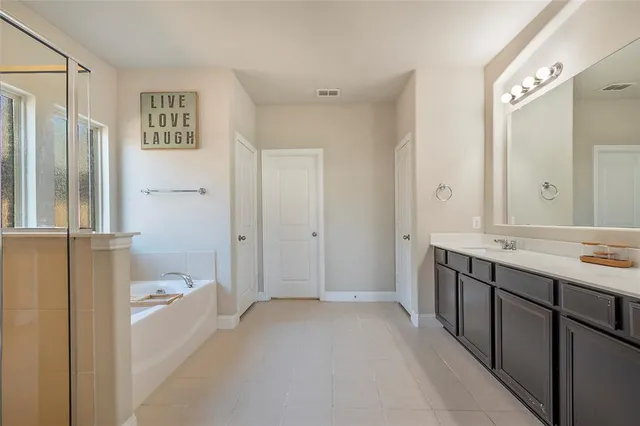 a bathroom with a bathtub and a shower