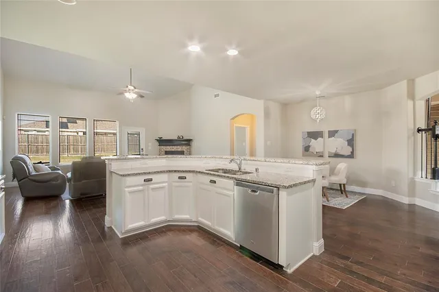a view of a yard in front of a house with a large tree