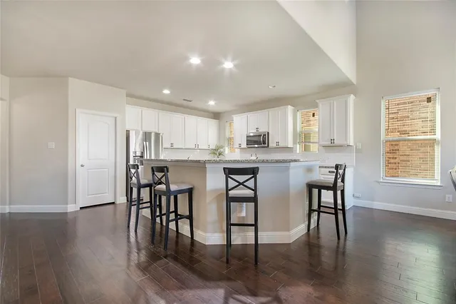 a kitchen with a sink cabinets and wooden floor