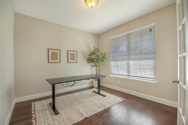 a kitchen with stainless steel appliances granite countertop a dining table chairs microwave and cabinets