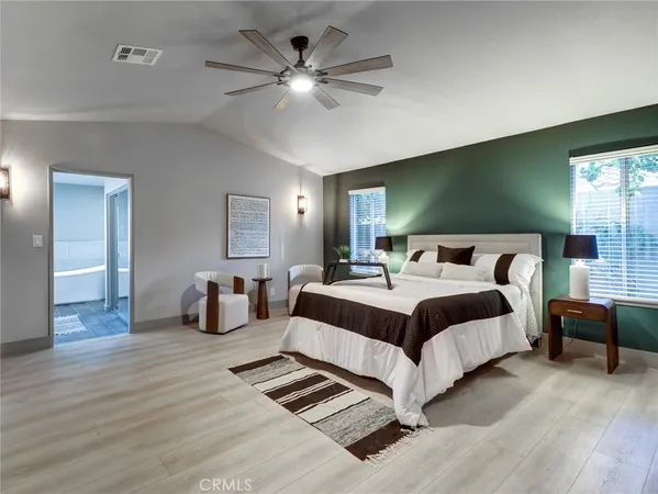 a bedroom with a bed and ceiling fan
