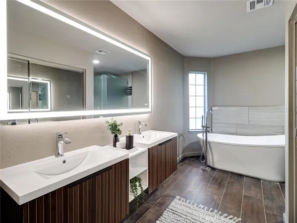 a bathroom with a tub sink and mirror