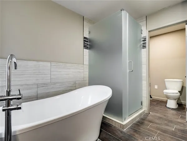 a bathroom with a bathtub and a toilet