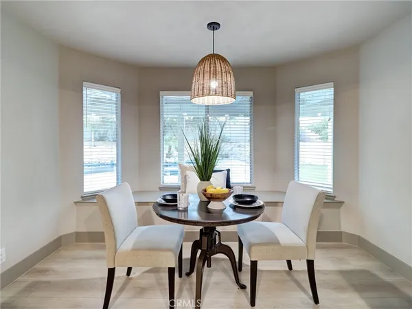 a dining room with furniture a chandelier and wooden floor
