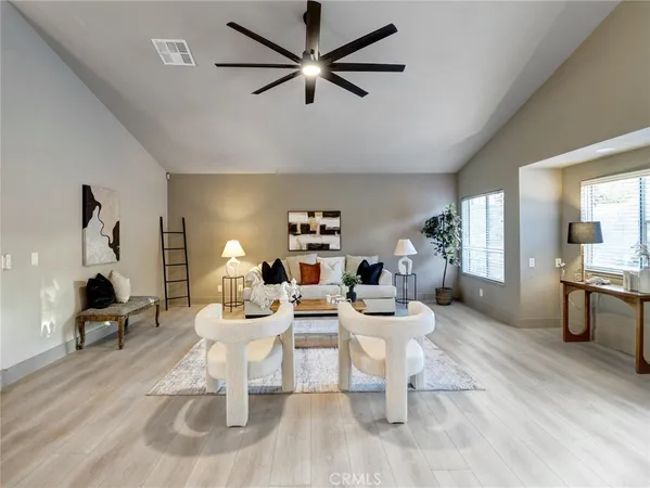 a living room with fireplace furniture and a wooden floor