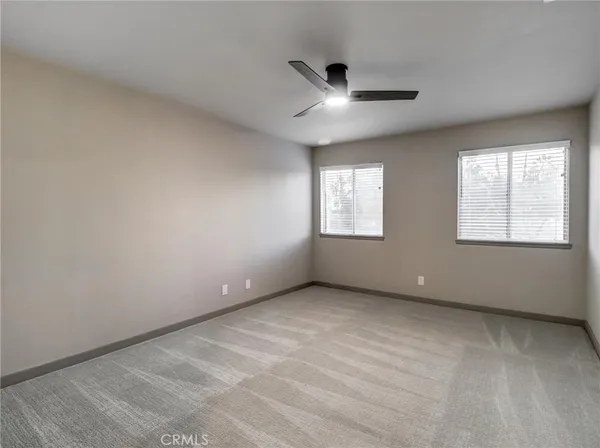an empty room with windows and closet