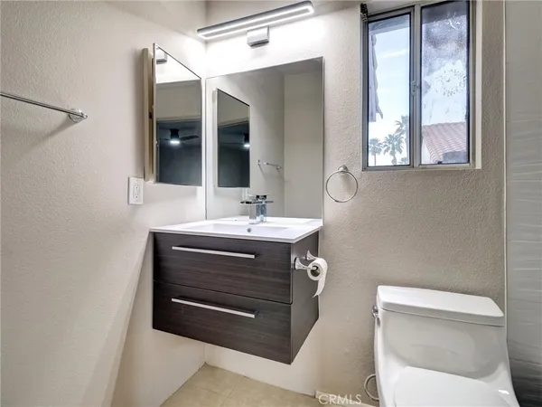 a bathroom with a sink vanity and mirror