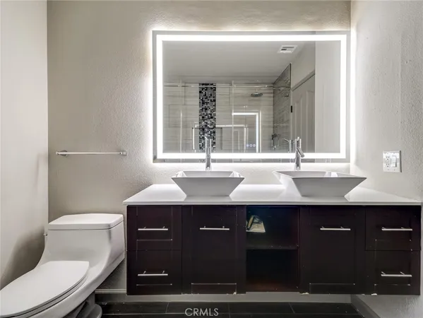 a bathroom with a sink double vanity and a toilet
