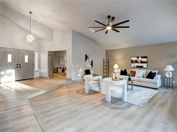 a living room with furniture and a chandelier