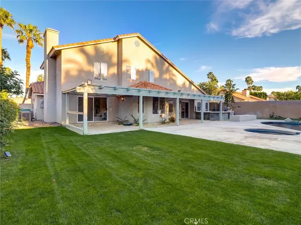 a view of a house with a backyard porch and sitting area