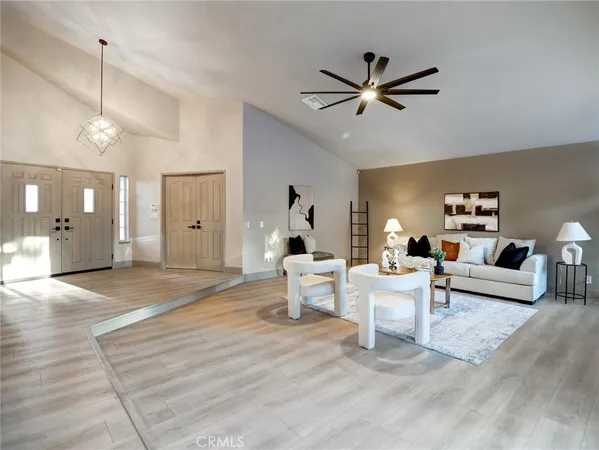 a living room with furniture and a chandelier