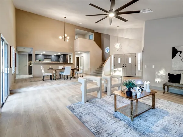 a living room with furniture and kitchen view