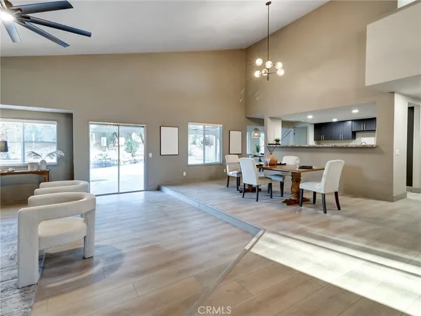 a living room with furniture and a dining table with kitchen view
