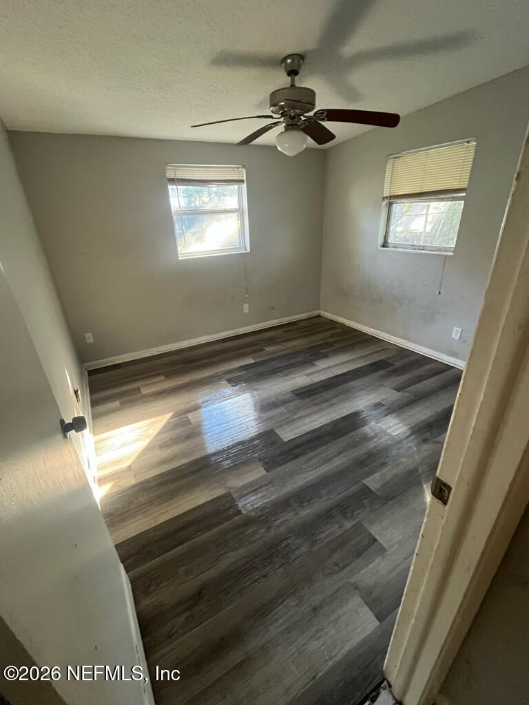 144 Spring Street Jacksonville, FL 32254 - Photo 5 of 7 a view of empty room with window and chandelier fan