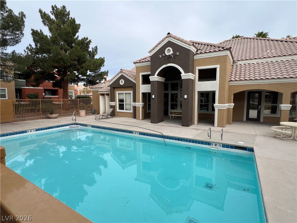 Community pool with a patio area