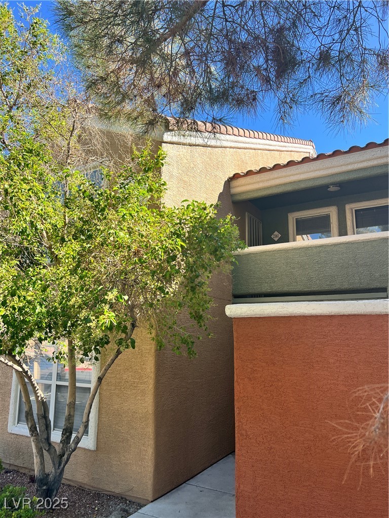 8101 West Flamingo Road, Unit 2161 Las Vegas, NV 89147 - Photo 21 of 21 View of side of property with a balcony and stucco siding