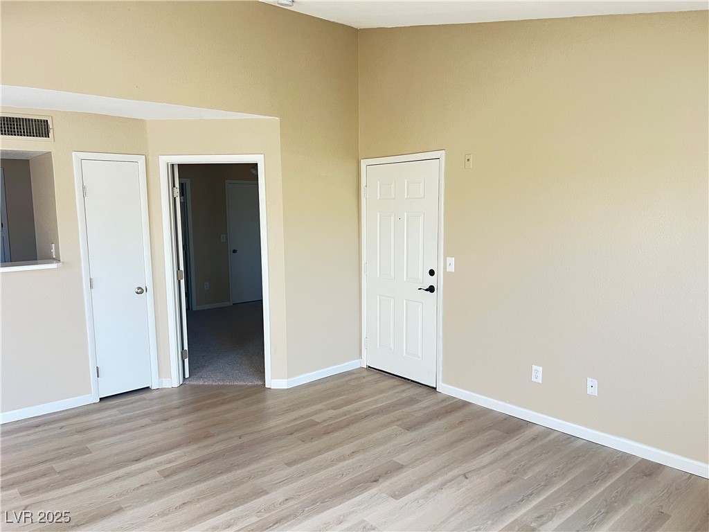 8101 West Flamingo Road, Unit 2161 Las Vegas, NV 89147 - Photo 3 of 21 Spare room featuring light wood-style flooring and baseboards