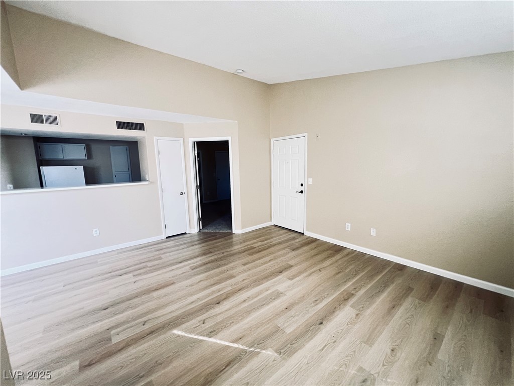 8101 West Flamingo Road, Unit 2161 Las Vegas, NV 89147 - Photo 6 of 21 Empty room with light wood-style flooring and baseboards