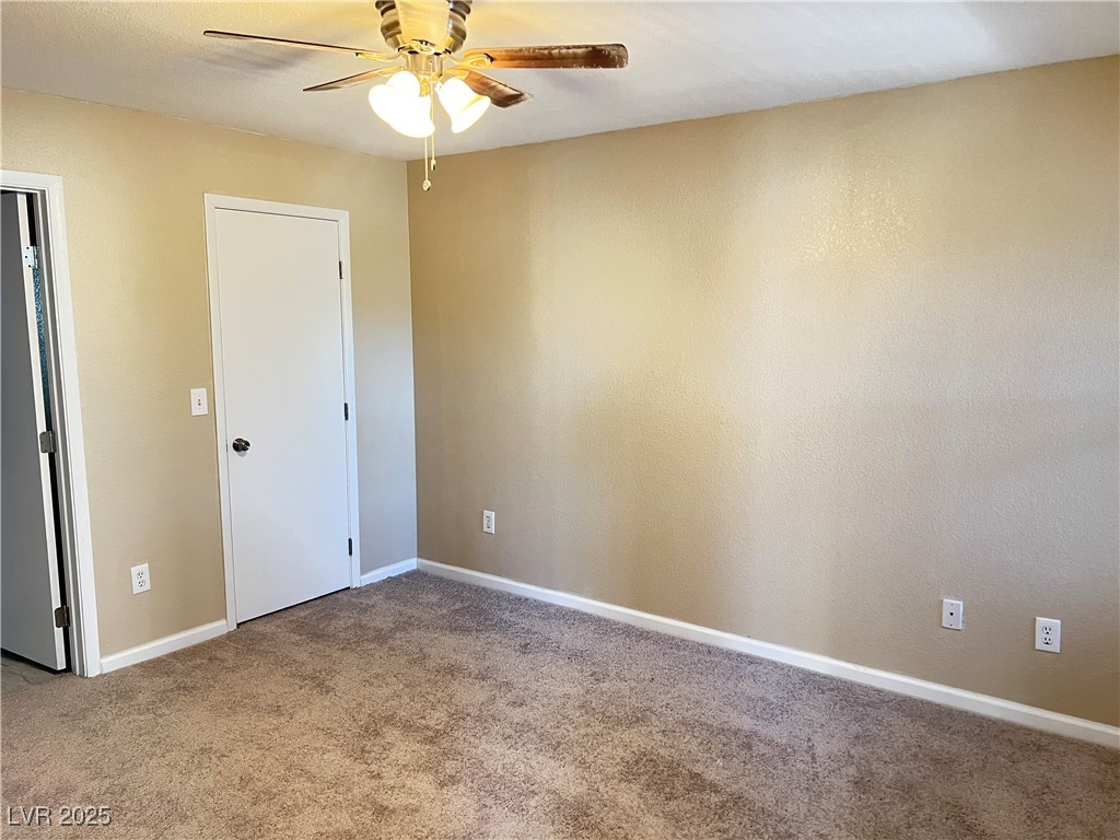 8101 West Flamingo Road, Unit 2161 Las Vegas, NV 89147 - Photo 9 of 21 Spare room featuring light carpet and a ceiling fan