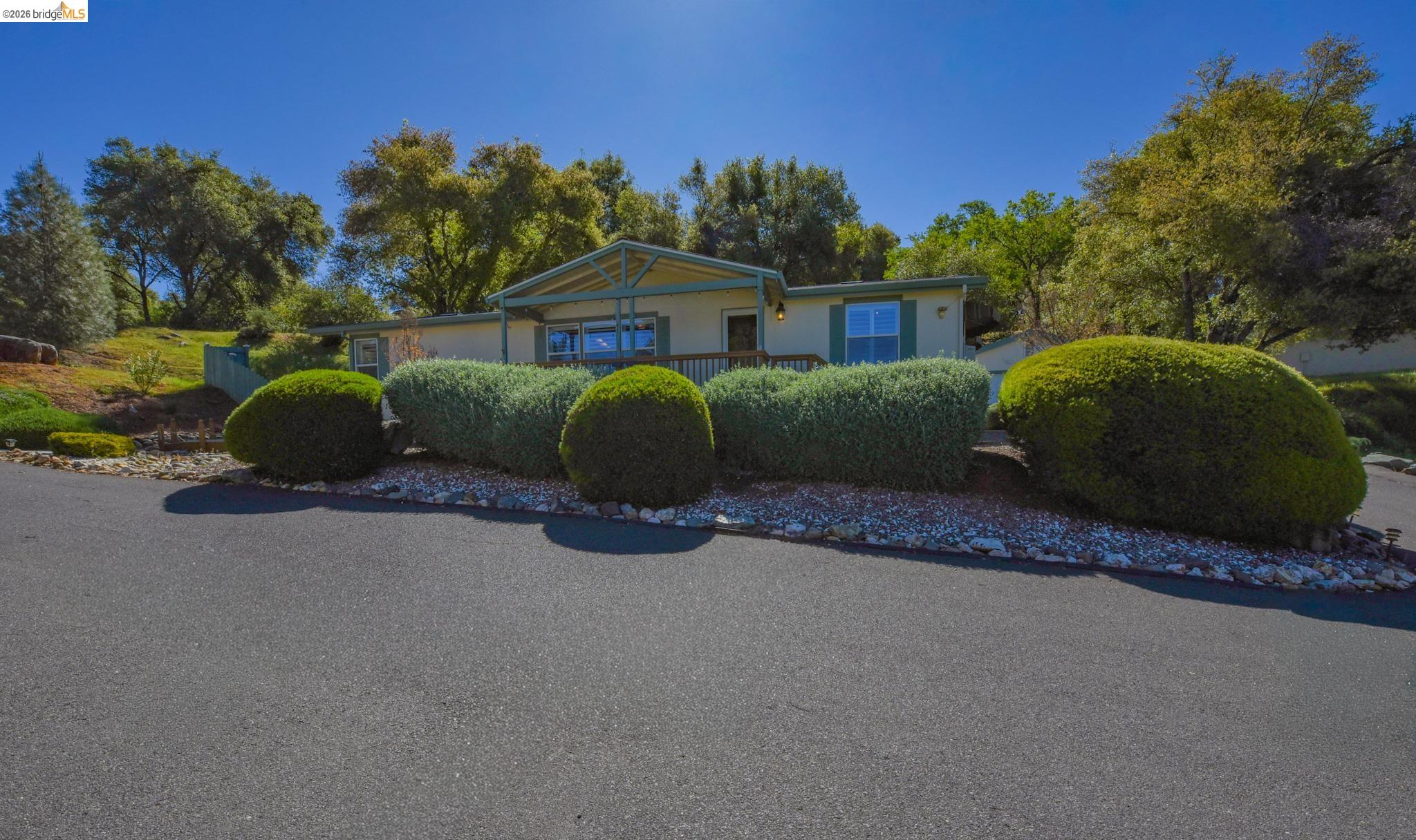 23732 Parrotts Ferry Road, Unit 47 Columbia, CA 95310 - Photo 1 of 21 a front view of a house with a garden