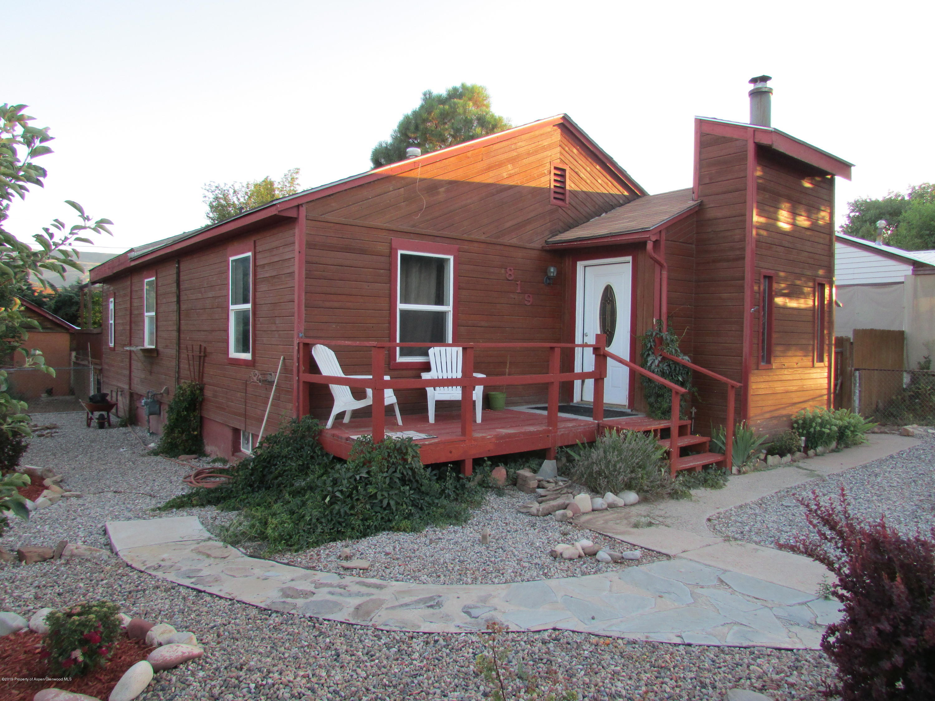 819 West 3rd Street Rifle, CO 81650 - Photo 1 of 17 a backyard of a house with yard table and chairs
