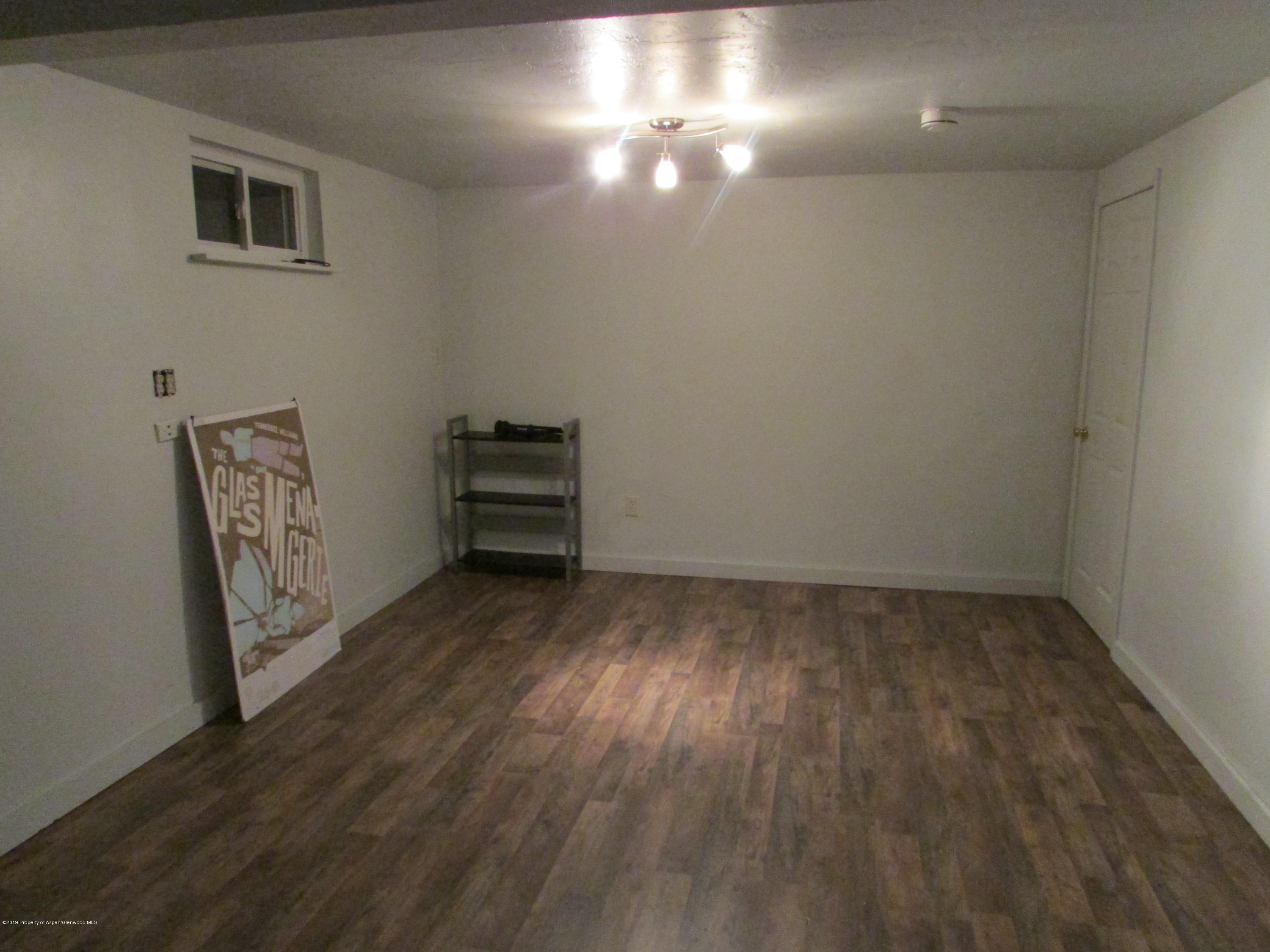 819 West 3rd Street Rifle, CO 81650 - Photo 12 of 17 a view of a room with wooden floor and a window