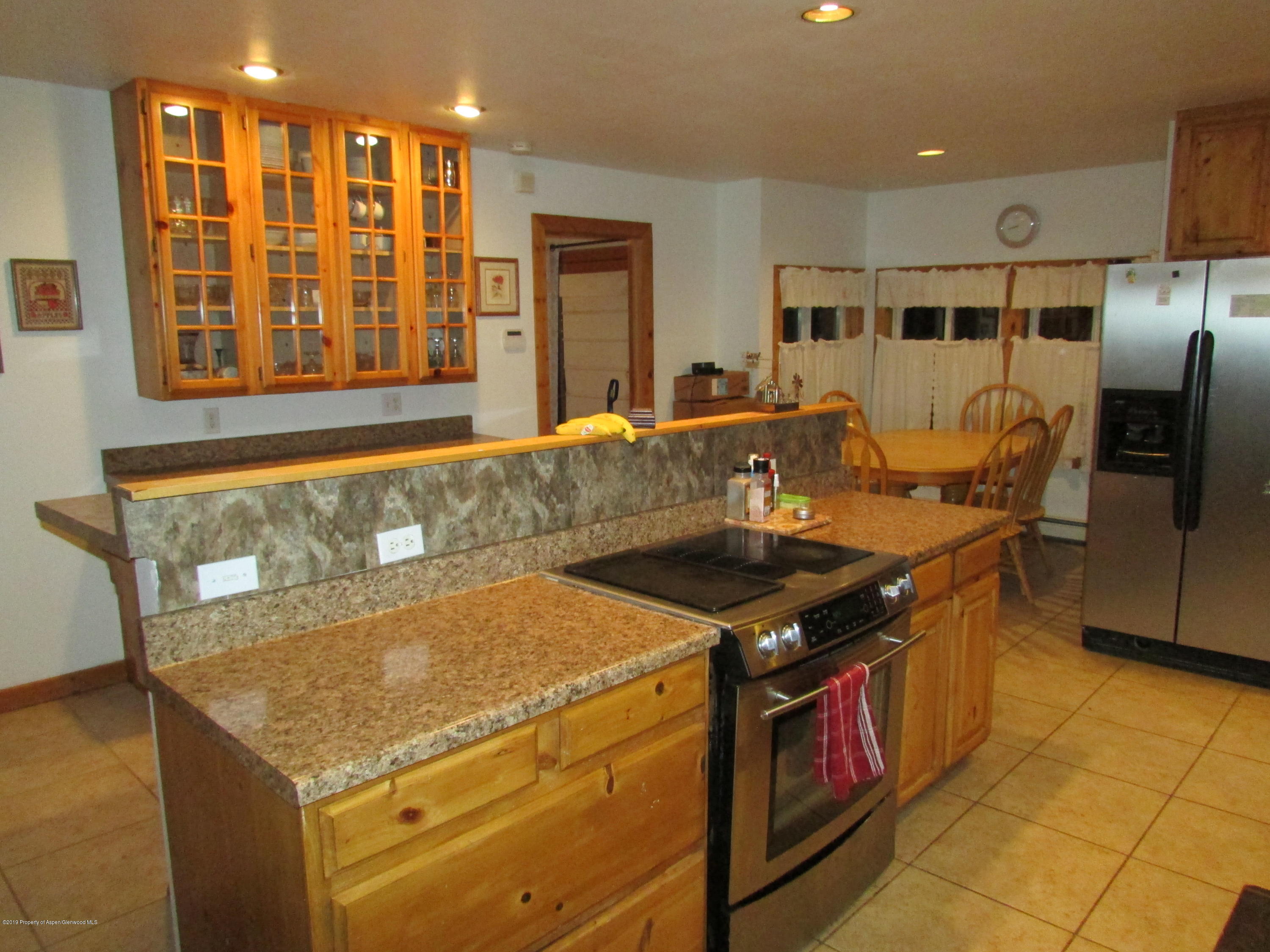 819 West 3rd Street Rifle, CO 81650 - Photo 4 of 17 a kitchen with a stove and a refrigerator