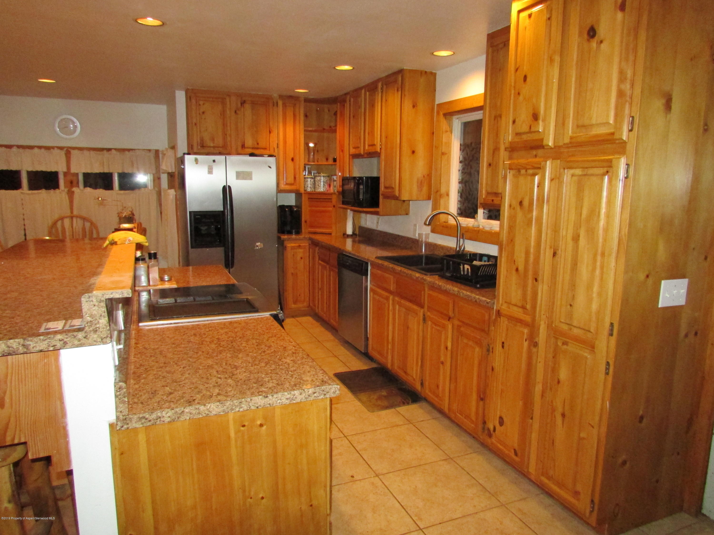 819 West 3rd Street Rifle, CO 81650 - Photo 5 of 17 a kitchen with stainless steel appliances granite countertop a refrigerator a sink and a stove
