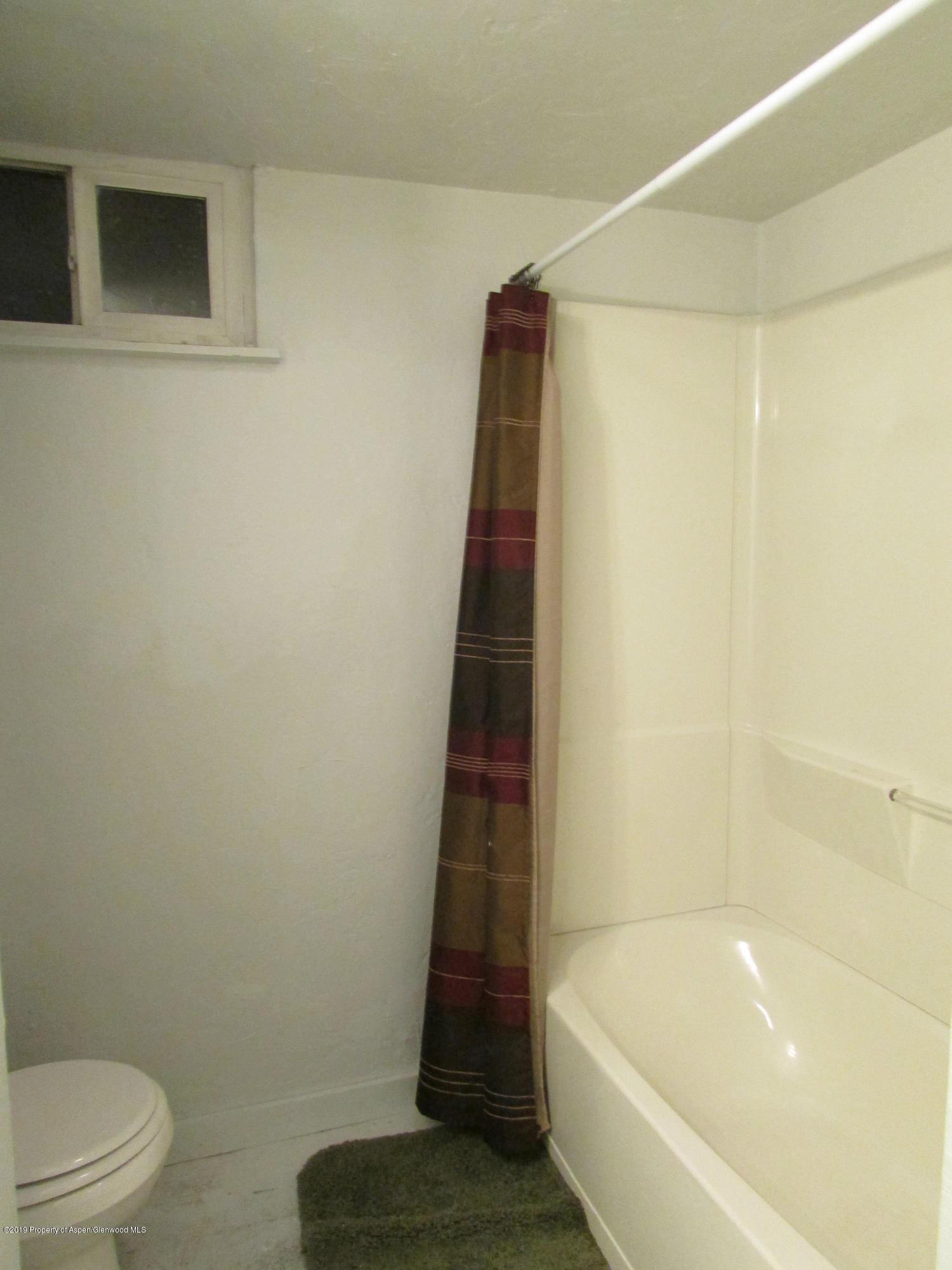 819 West 3rd Street Rifle, CO 81650 - Photo 10 of 17 a bathroom with a shower and a toilet