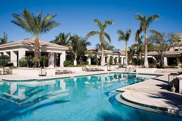 2727 Anzio Court, Unit 106 Palm Beach Gardens, FL 33410 - Photo 28 of 43 a view of house with swimming pool and outdoor seating