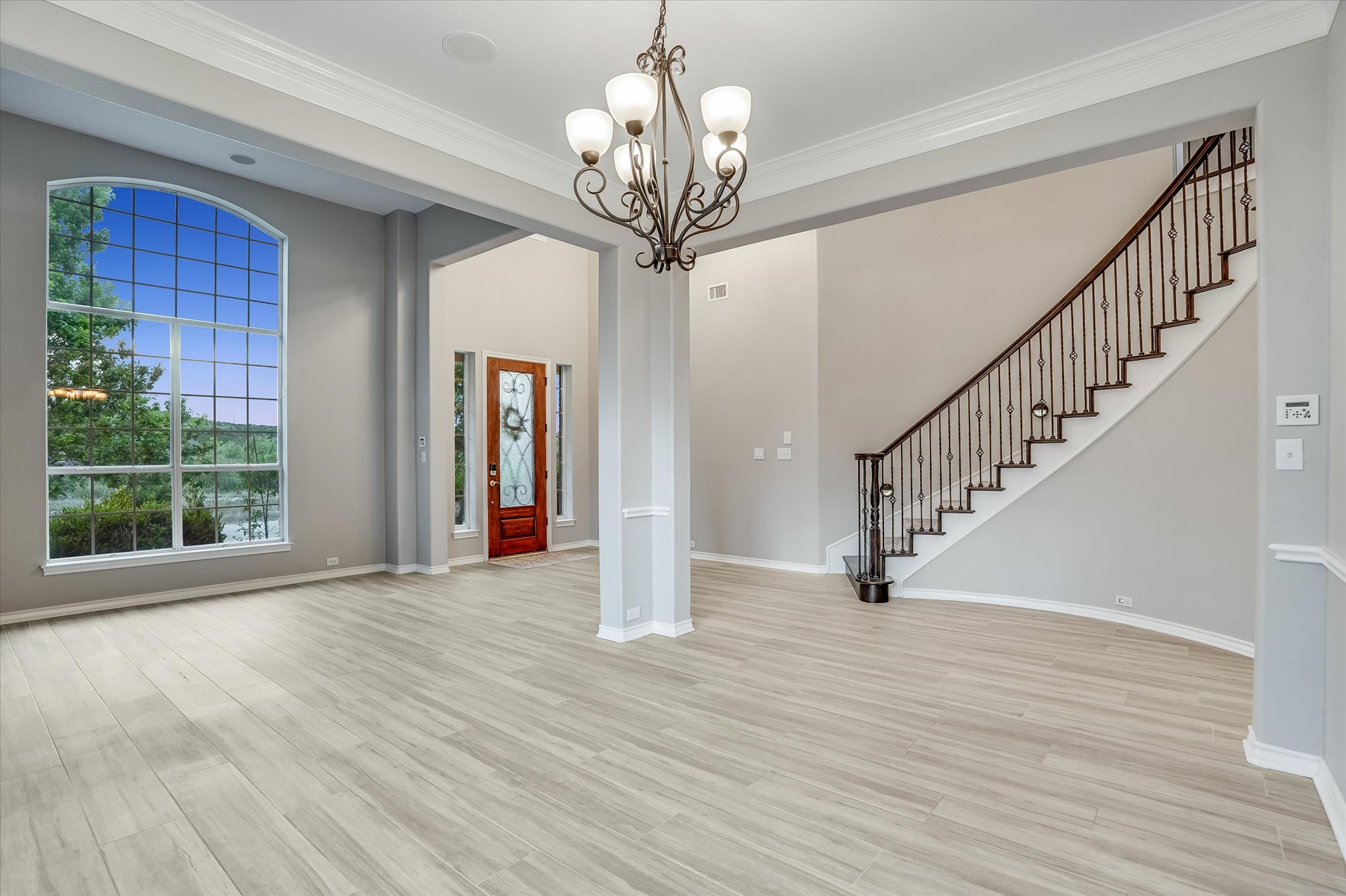 1400 Tom Sawyer Road Austin, TX 78737 - Photo 6 of 40 Bright entry with updated flooring (2020) and a grand staircase setting the tone for the home.