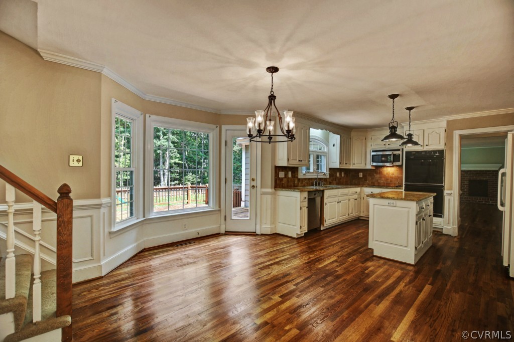 14163 Grangewood Road Midlothian, VA 23113 - Photo 16 of 24 a kitchen with a refrigerator and a stove top oven