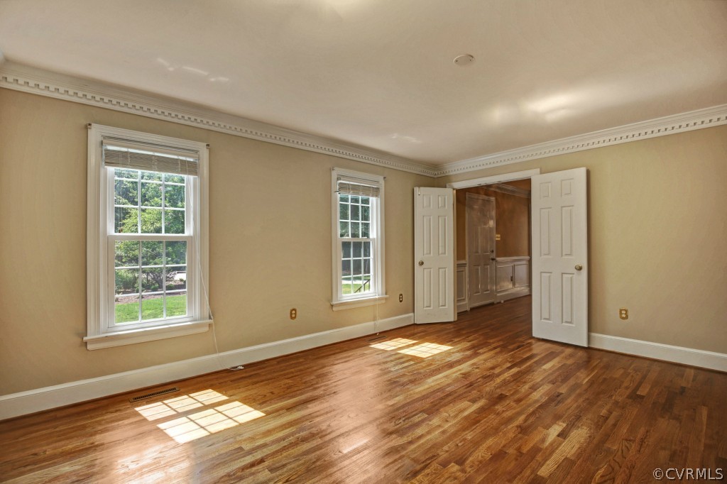 14163 Grangewood Road Midlothian, VA 23113 - Photo 7 of 24 a view of an empty room with wooden floor and a window