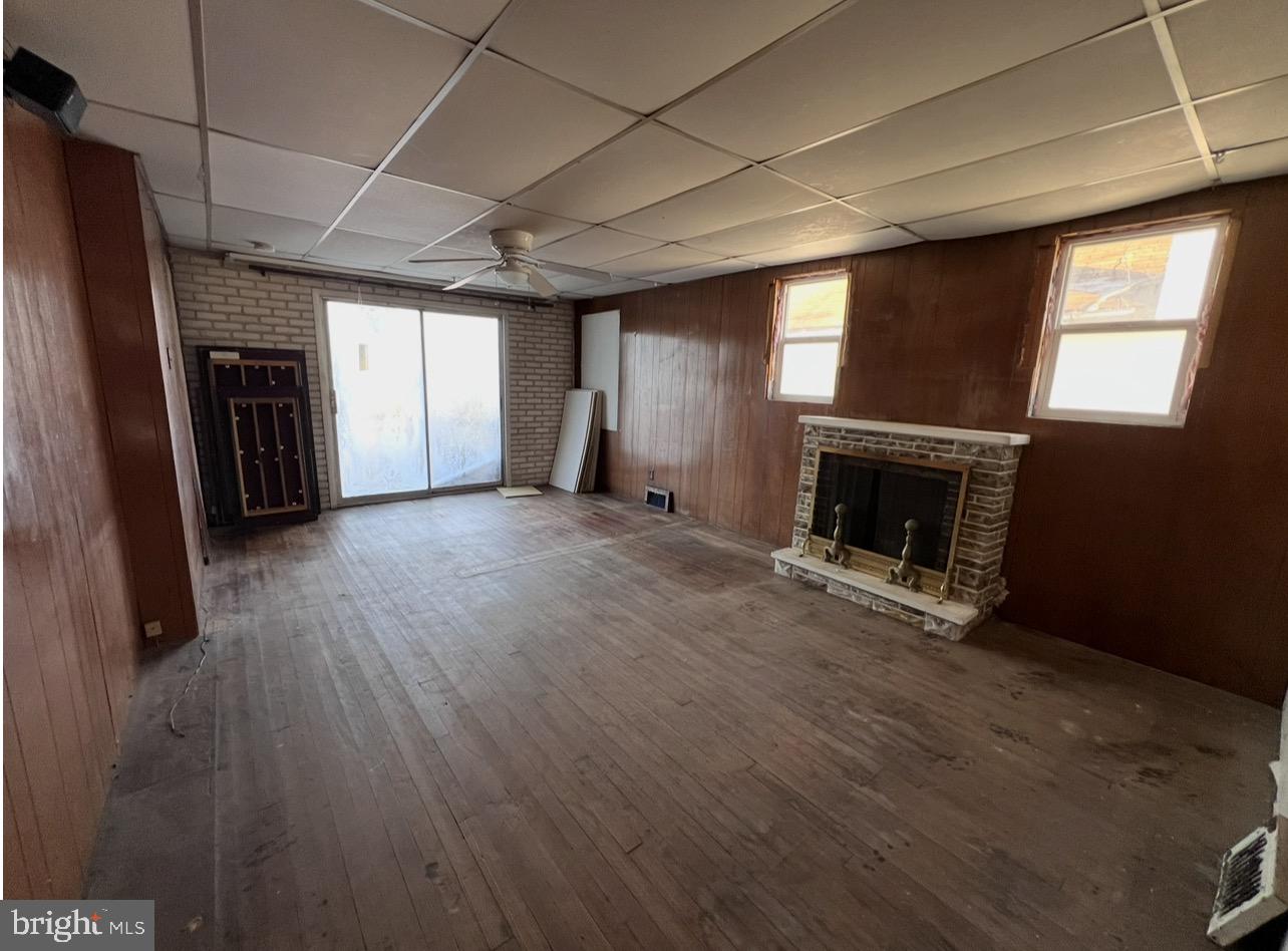 13 Beach Road Glen Burnie, MD 21060 - Photo 7 of 20 a view of empty room with wooden floor and fireplace