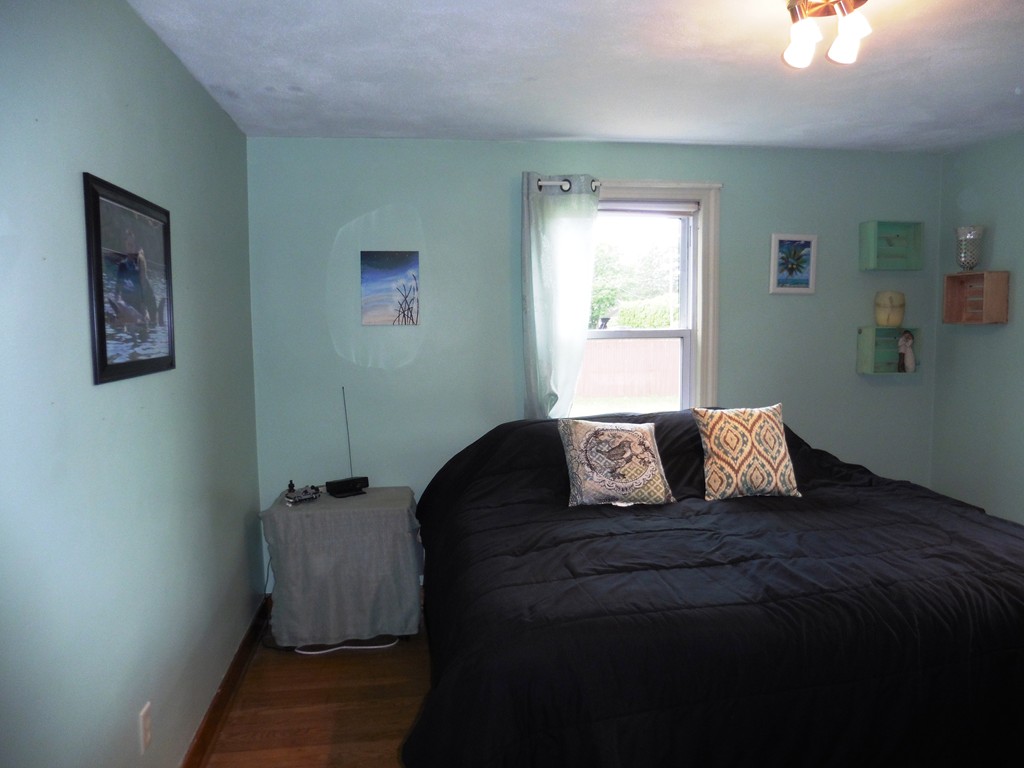 2020 Pine Street Three Rivers, MA 01080 - Photo 12 of 24 a bed sitting in a bedroom next to a window