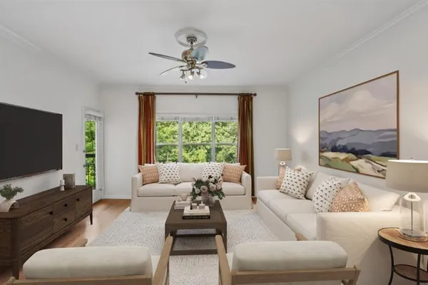 a living room with furniture and a flat screen tv