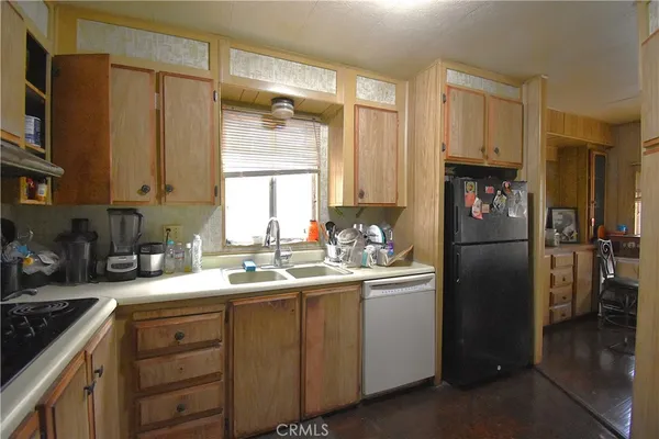 a kitchen with a sink stove and refrigerator