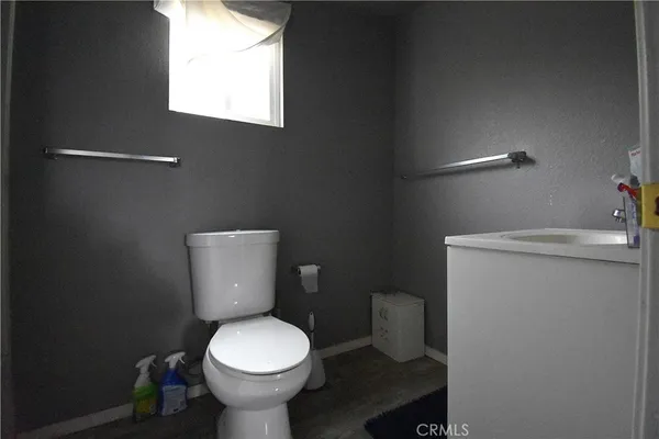 a white toilet sitting next to a bathroom sink