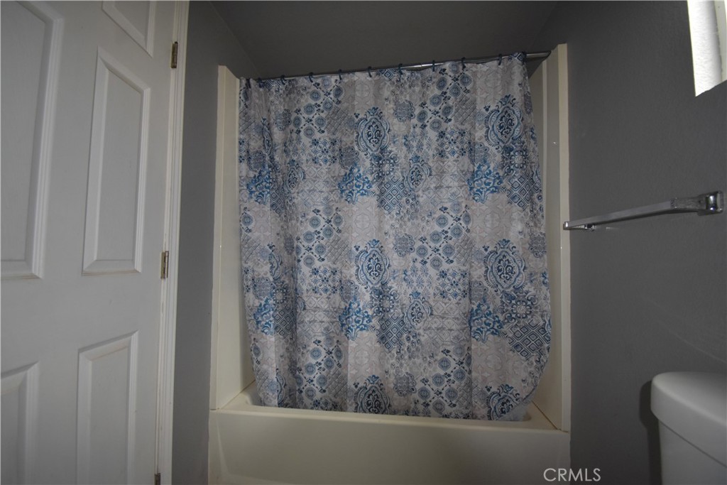233 Renegade Road Oroville, CA 95966 - Photo 14 of 44 a bathroom with a shower curtain
